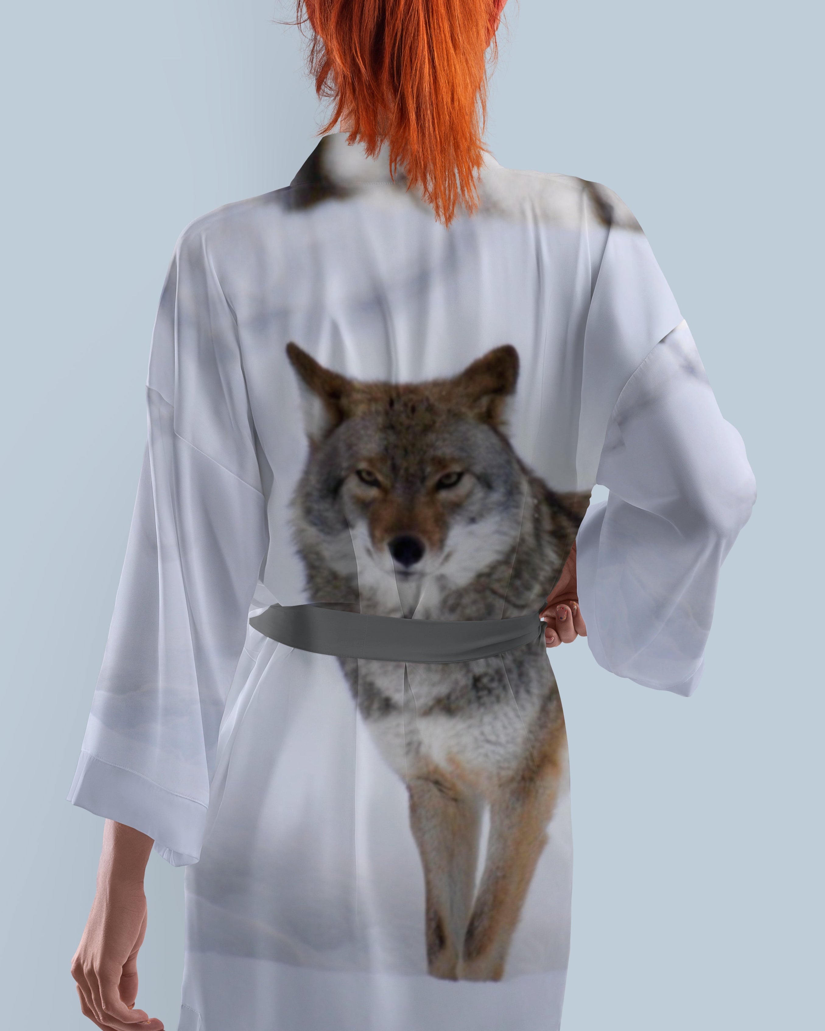 Person wearing a kimono robe with a coyote design and grey belt